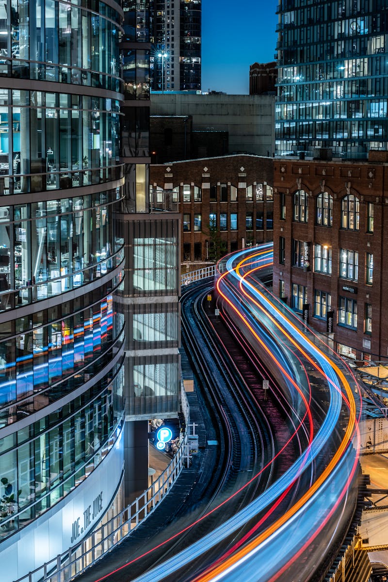 Time-Lapse Photography of Railway and Building during Nighttime