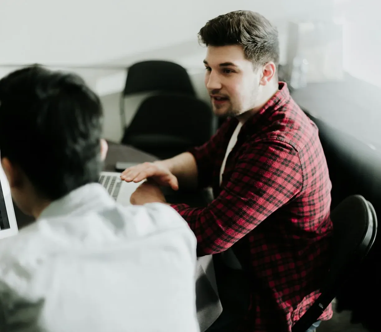 a man sitting in front of a laptop computer