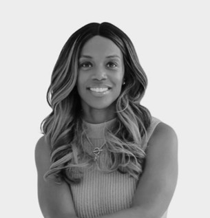 Smiling woman with long hair, arms crossed.