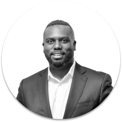 Smiling man in a suit, monochrome portrait.